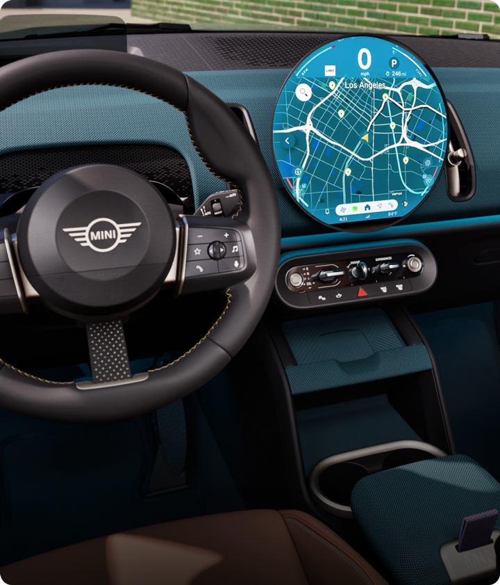 The interior of the MINI Countryman S ALL4 with a focus on the steering wheel and display.