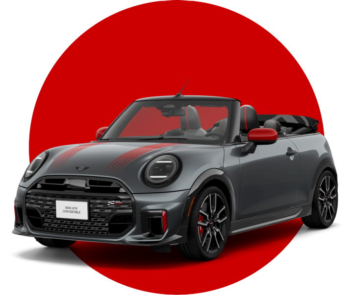An angled view of a 2025 JCW Convertible in front of a red circle against a black backdrop