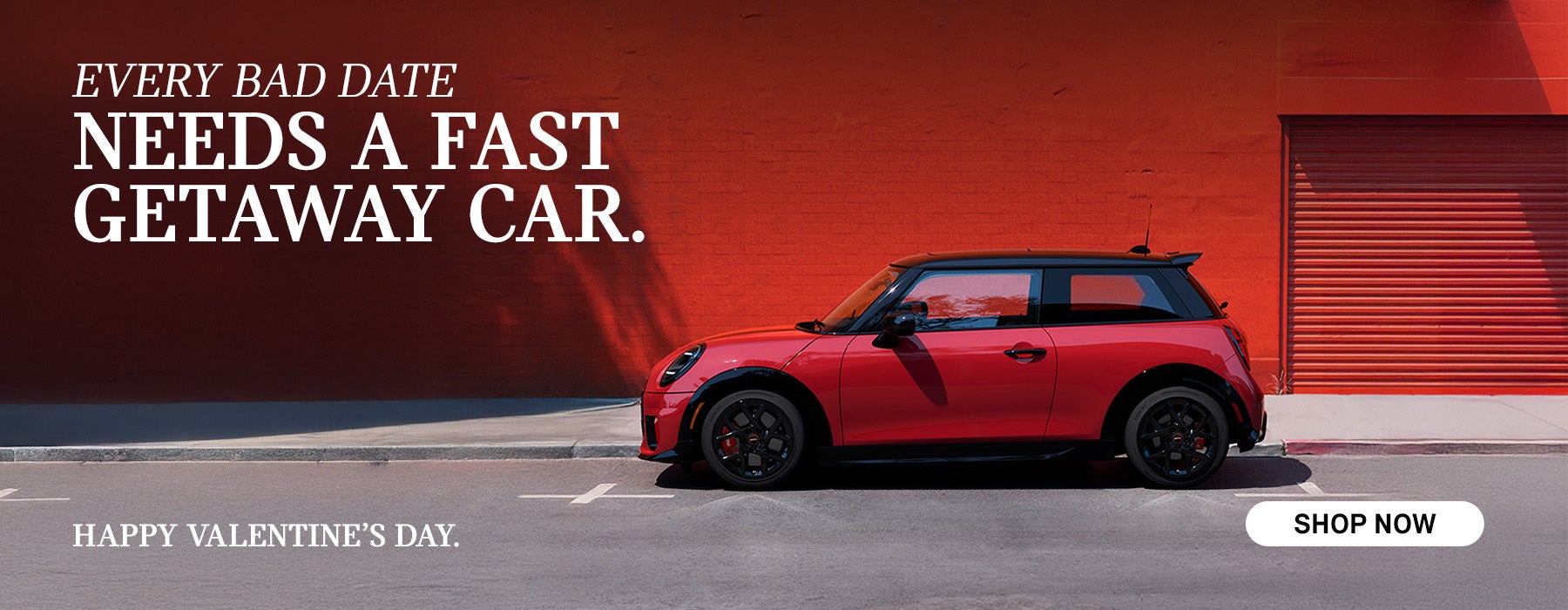 side view of red MINI infront of red wall.